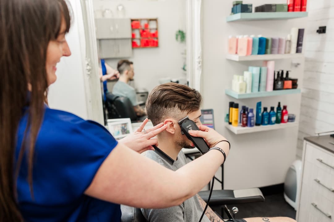 Rachel giving a professional men's haircut at Hair by Rachel salon in Hendersonville, TN